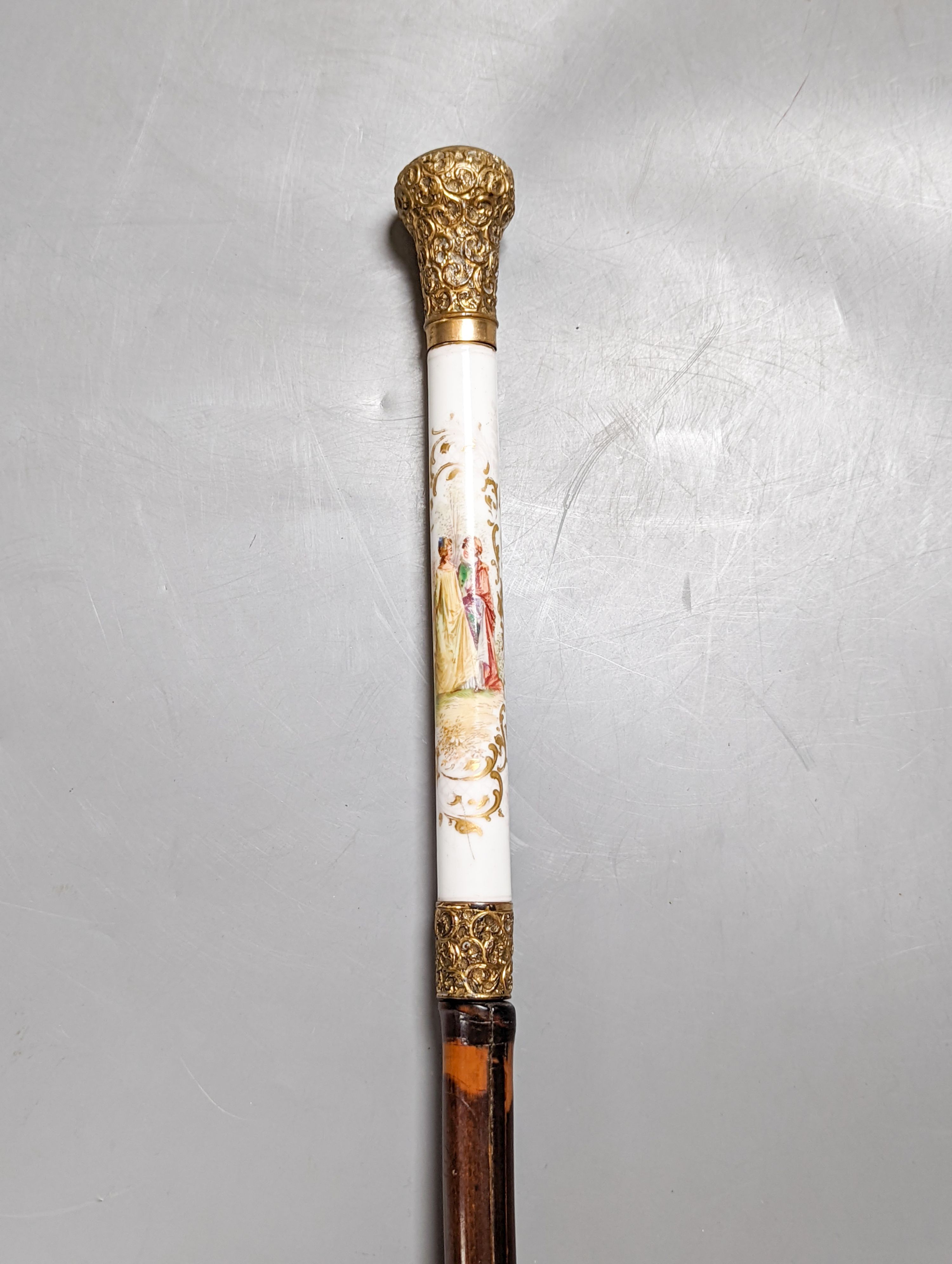 A porcelain mounted sword stick with gilt decoration to blade